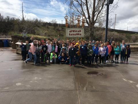 All of third grade students and teachers in front of the African Savanna sign