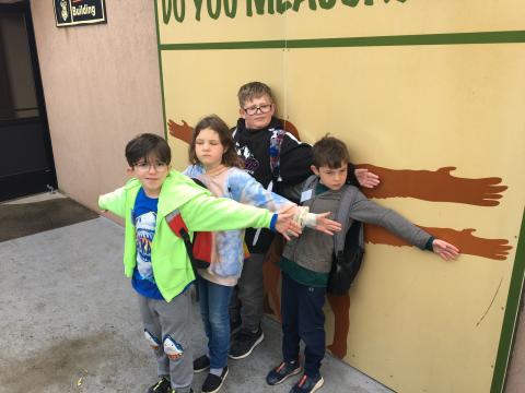 Students measuring their arm span compared to the primates. 