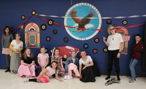 students posing in front of fifties decorations 
