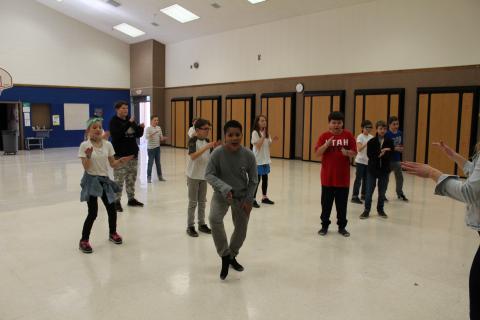 Students learning the hand jive