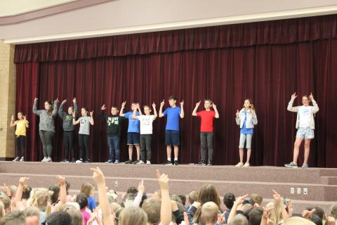 Student council leading the student body in the school song