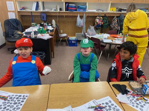 Students dressed as Mario and Luigi, playing games