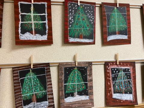 Multiple Students artwork of a Christmas tree through a cabin window
