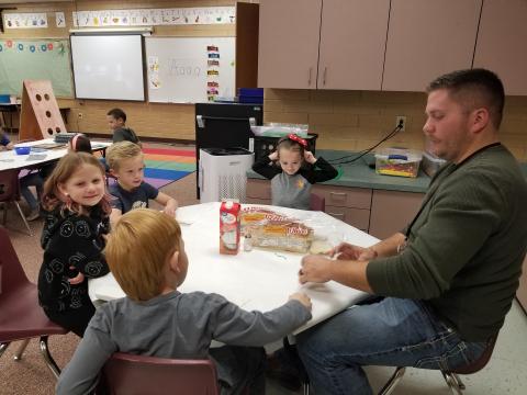 Kindergarten students eating bread