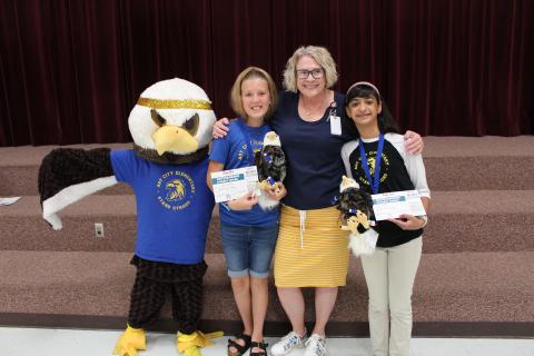 Mrs. Muirbrook, ACE the Eagle with two students who received the Golden Eagle both years.