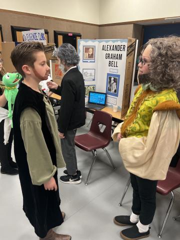 Students talking to wax Museum figures