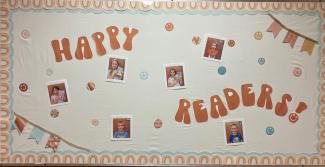 Library bulletin board:  Happy Readers. Six students holding their favorite books