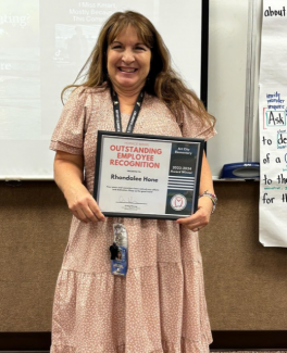 Rhonda Hone holding her certificate of recognition