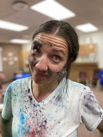 A PTA mom covered in chalk after the chalk fight