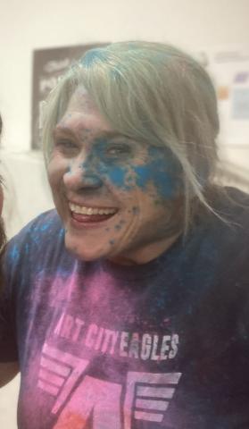 Mrs. Muirbrook with blue chalk on her face and covered in chalk after the chalk fight