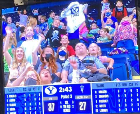 Students at a BYU Women's Basketball game on the Jumbo Tron
