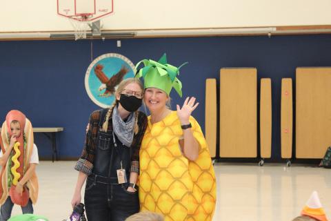 Mrs. Roundy and Ms Weeter as a farmer and a Pineapple
