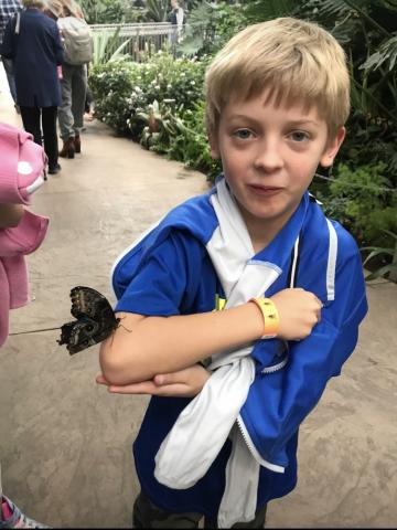 Student with a butterfly on his elbow. 