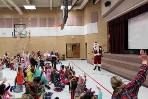Santa has arrived, students are singing with Santa