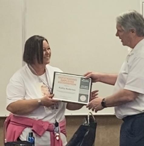 Kathy Anderton accepting the Employee recognition from Horace Mann