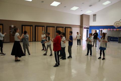 Students learning the hand jive