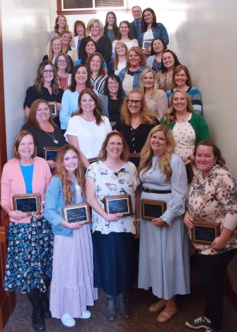 Jamie Houston second row on the left, 29 other teachers recognized for teacher of the year.