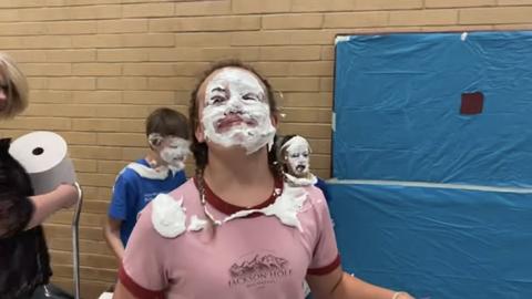 student with cream on her face