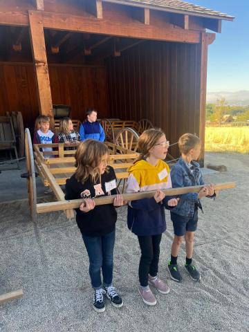 4th grade students pulling a hand cart at This is the Place Heritage Park