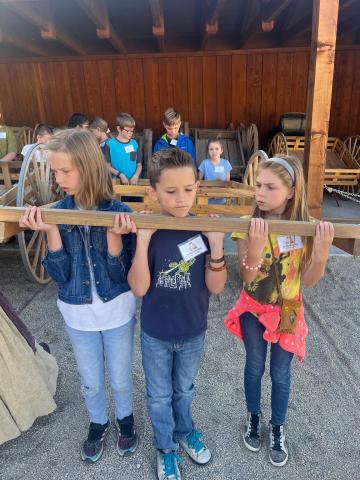 4th grade students pulling a hand cart at This is the Place Heritage Park