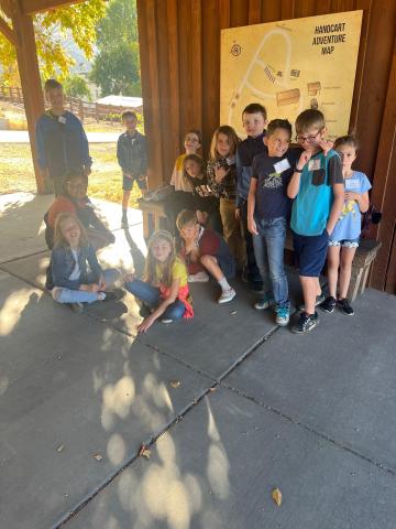 4th grade students standing in front of a map  at This is the Place Heritage Park