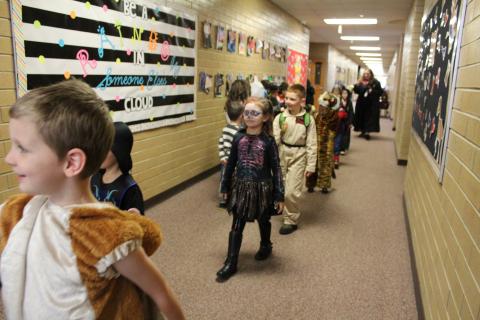Students in costume walking in the parade