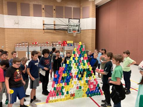 Students creating a Cup Stacker tower