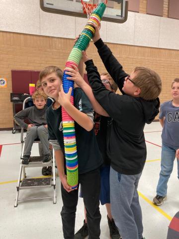 Students Stacking all the cups in one stack