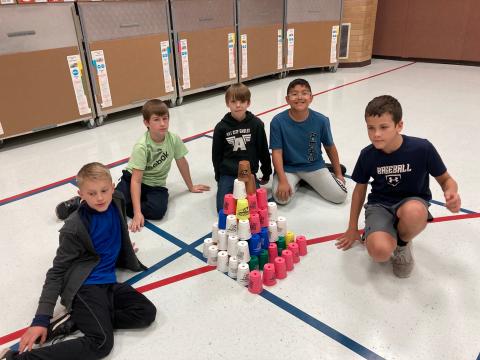 Students with a three dimensional tower of cups