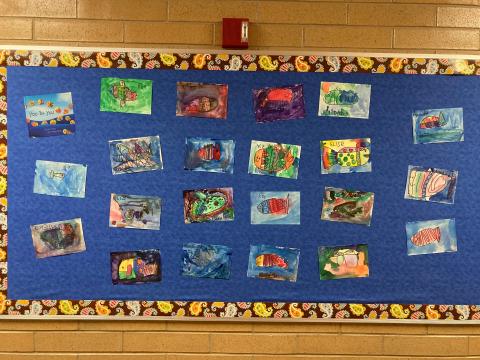 Bulletin board with students fish drawings