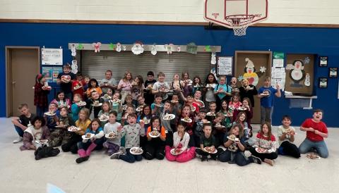 All of the Fourth grade classes holding their Gingerbread creations