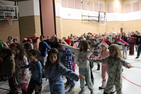 Students doing the Gingerbread man dance