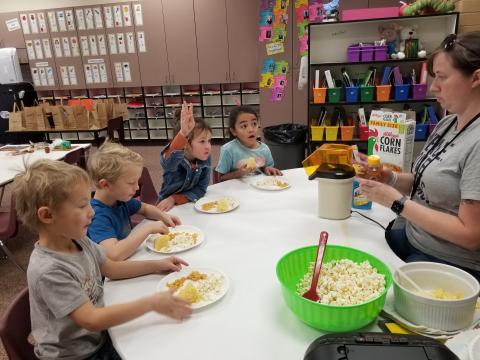 Kindergarten students eating popcorn