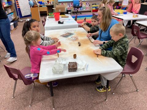 Kindergarten students making clay pots