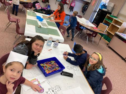 Kindergarten students coloring pilgrims