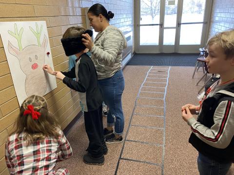 Students playing "Pin the Nose on Rudolf"