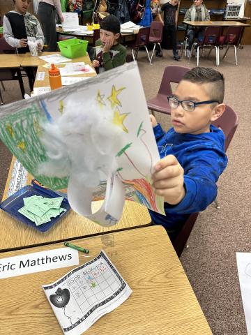 Student proudly holding his 3-D Art 