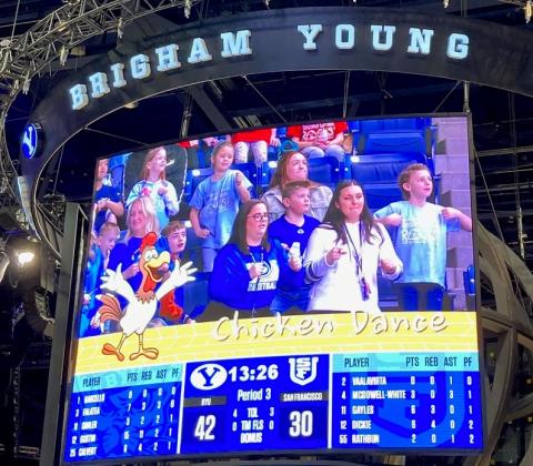 Students and teachers featured on the Jumbo Tron during the Chicken Dance 