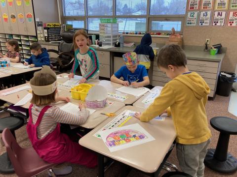First grade students creating 100 Day pictures