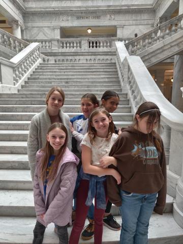 Students standing at the base of the steps inside the Capitol