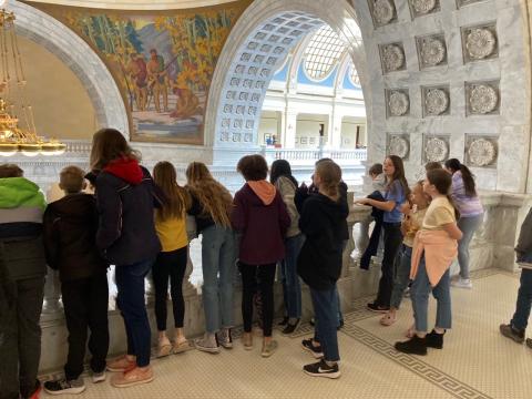 Students looking over the banister in the State Capitol building
