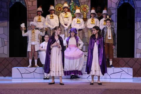 The narrators with the candles, Mrs. Potts, Chip, Cogsworth, and Lumiere