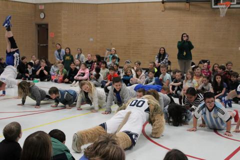 Students participating in a push-up competition with students 