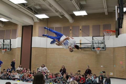 Member of the Dunk team soaring through the air