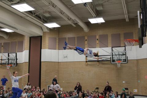 Member of the Dunk team soaring through the air