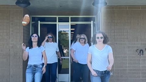 Office staff strutting out of the building with sunglasses on