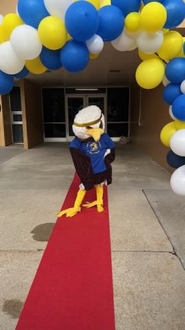 The Art City Eagle on the red carpet under the balloon arch