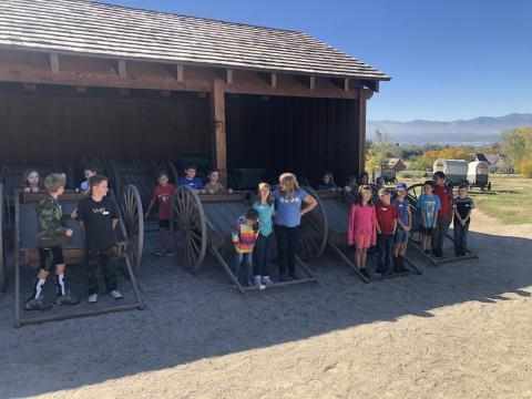 Fourth grade students pose in and around the hand carts