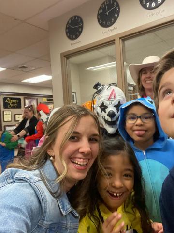 selfie picture of students in costume with Mrs. Anderson