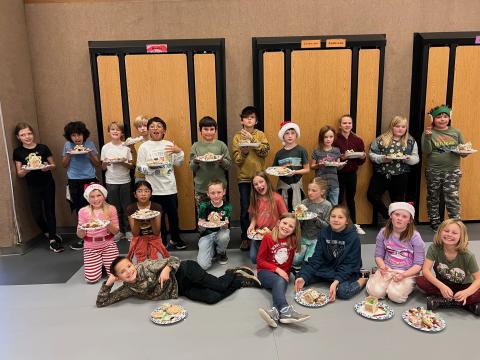 4th grade students holding their Gingerbread Creations